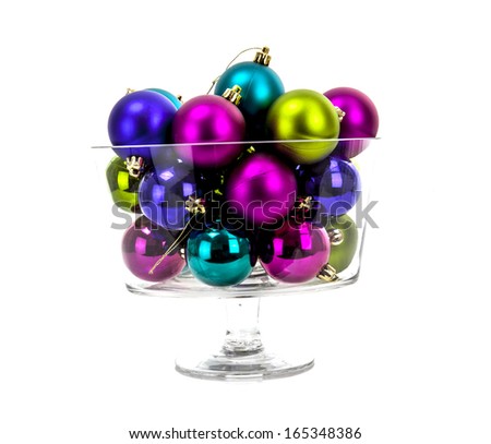 Multi-colored Christmas balls in a glass isolated on white