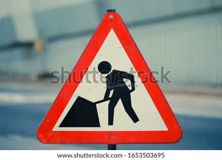 worker construction sign in red 