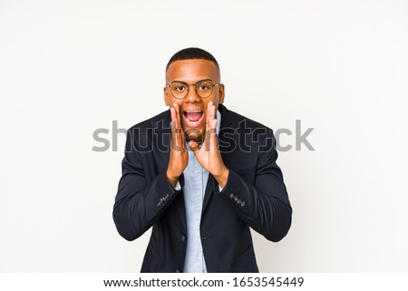 Young business latin man isolated on white background shouting excited to front.