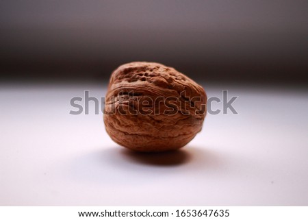 one walnut lies on a white surface