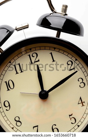 Black retro alarm clock showing differnt times