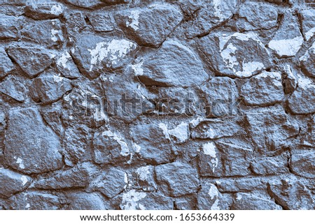 Texture of the Stone wall for backgrounds. Color tinted in blue sepia. Stock photo