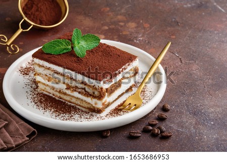 Traditional italian dessert tiramisu on a white plate. Copy space. Selective focus Royalty-Free Stock Photo #1653686953