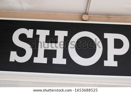 Store sign shop facade text on retail building front view business boutique