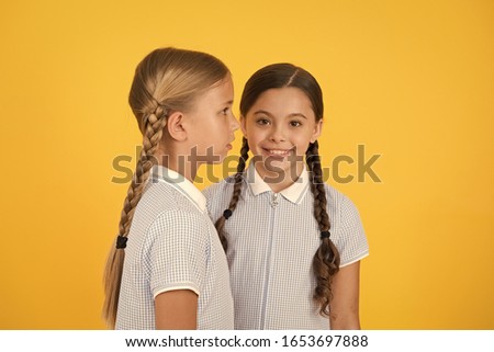 small girls in retro uniform. old school fashion. back to school. happy beauty with pigtails. happy childhood. brunette and blond hair. sisterhood concept. best friends. vintage style. Beauty salon