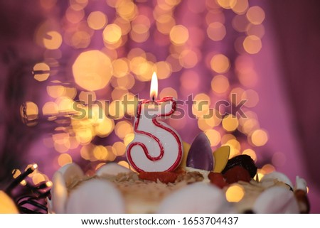 Festive close-up background of a burning candle