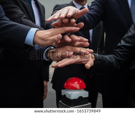 hand from businessmen pushing red button for kickoff Royalty-Free Stock Photo #1653739849