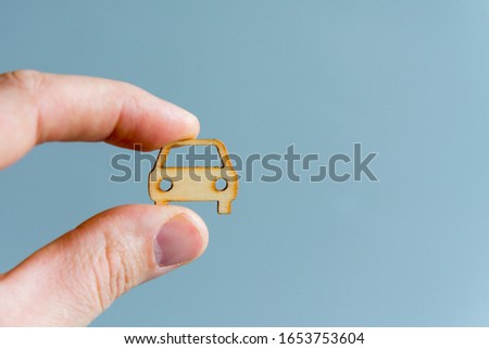 Car insurance concept. Protection of car (concept). Hand holding car model on gray background