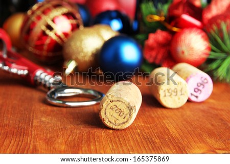 Wine corks with new Year toys on wooden table close-up