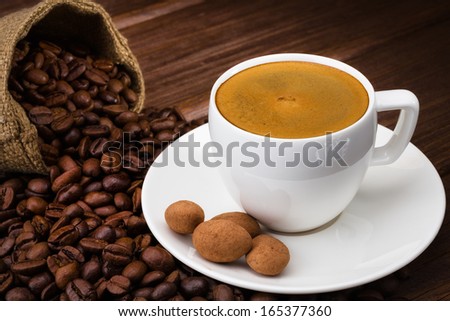 Coffee cup on a wooden table. Dark background.