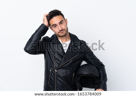 Man with a motorcycle helmet with an expression of frustration and not understanding