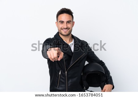Man with a motorcycle helmet making phone gesture and pointing front