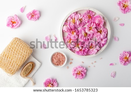 Spa settings with roses. Fresh damask roses and rose petals and various items used in spa treatments.