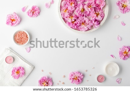 Spa settings with roses. Fresh damask roses and rose petals and various items used in spa treatments.