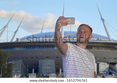portrait of a young man selfi on the background of the stadium