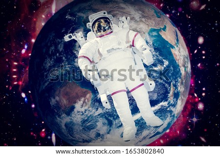 Astronaut and the earth. The elements of this image furnished by NASA.
