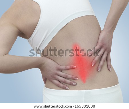 Acute pain in a woman back. Concept photo with blue skin with read spot indicating pain. 
