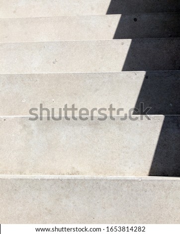 Shadow on the gray stairs.
