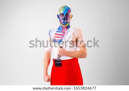 A strange man with makeup on his head and shoulder in white t-shirt, red pants