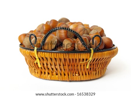 Wood nuts in a basket isolated on a white background