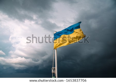 Ukrainian flag in the wind. Blue Yellow flag Against the background of a stormy sky Royalty-Free Stock Photo #1653837706