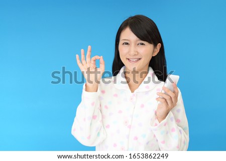 Woman with ok hand sign.