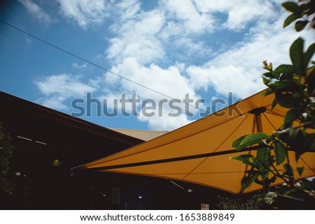 street sky clouds umbrella yellow