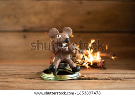Rats from plasticine holding a power cord.breaking the wires. Electric shock,An explosion,Fire.
