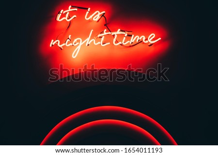 Red neon light sign with a Title: "It is nighttime".