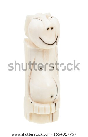 traditional bone carving of the peoples of the north of Russia (Chukchi) - Peliken statuette carved from walrus ivory isolated on white background