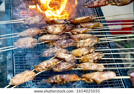 Delicious outdoor grilled chicken wings Royalty-Free Stock Photo #1654025035