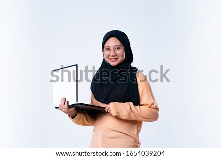 Happy female student with holding laptop isolated on a white background. Looking at camera