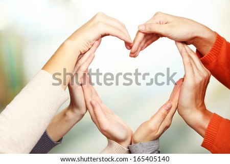 Human hands in heart shape on bright background Royalty-Free Stock Photo #165405140