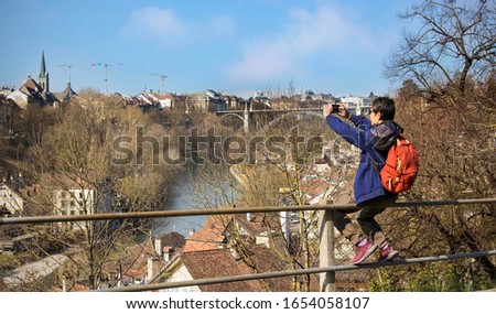 Panoramic view with young man  tourist take a photo by smartphone in Bern,Switzerland