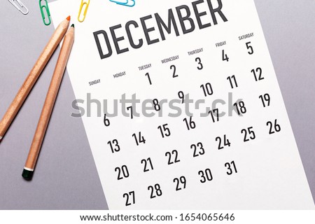 December 2020 simple calendar with office supplies and copy space