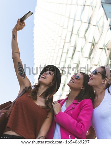 Three Beautiful Women Taking Selfie Outdoors. Group of Friends Having Fun Outdoors. Three Female Friends Taking Selfie and Smiling. Lifestyle Concept.