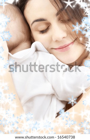 picture of happy mother with baby boy and snowflakes