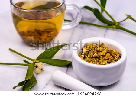 Mistletoe, tea with mortar and frehs and dried mistletoe drug