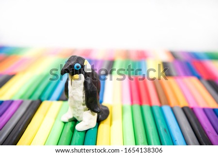 Play clay Animals. Penguin on colored background.