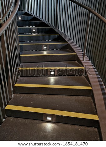 Stairs with lighting and yellow anti-slip treads and nosings.  Royalty-Free Stock Photo #1654181470
