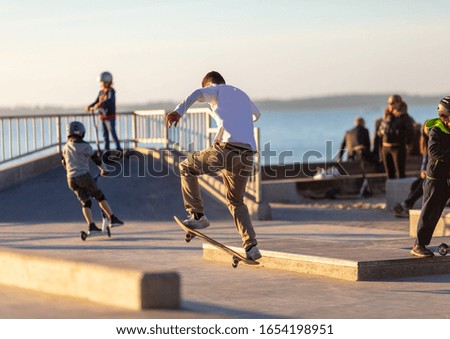 Young Man riding Skateboard on a Skate Park