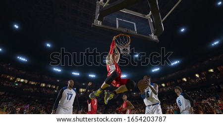 Basketball players on big professional arena during the game. Tense moment of the game. View from below the basket