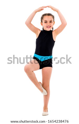 Girl child practice and doing rhythmic gymnastics portrait, white background. Young girl is dancing and having fun performing rhythmic gymnastics exercises. Isolated on white background.