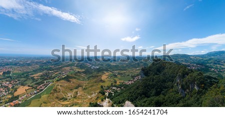 Aerial view on Third, distant tower on top of the mountain. Fortifications, in the background mountains and the city. The concept of wide panorama wallpaper Europe. San Marino, Italy
