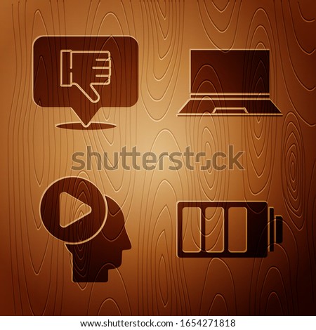 Set Battery charge level indicator, Dislike in speech bubble, Head people with play button and Laptop on wooden background. Vector