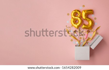 Number 85 birthday balloon celebration gift box lay flat explosion Royalty-Free Stock Photo #1654282009