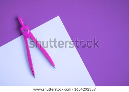 School supplies on purple background. Workspace of student or office worker