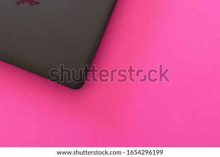 Pink background laptop on the left. Flat color design computer for developer technology advertising. Women empowerment in tech concept in bright colors top view
