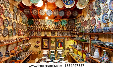 Colorful Turkish traditional ceramic handycrafts in a local pottery shop in Cappadocia Royalty-Free Stock Photo #1654297657