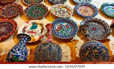 Colorful Turkish traditional ceramic handycrafts in a local pottery shop in Cappadocia Royalty-Free Stock Photo #1654297699